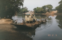 Car ferrying cars across a river in Congo where a bridge was demolished