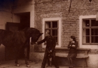 Sister Blažena in front of the farm in Příkazy, 1940s. On the right in the photo the pump of the Sigmund brothers from Lutín