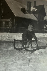 Sledging in front of the family house, Vrchlabí, around 1956