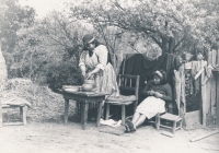 A Mapuche woman making pottery to sell at the market