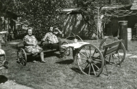 Na dvoře nového domu rodiny Krajíčkovy. Zleva sedící sousedka Kročková a Jiří Krajíček, 80. léta 20. století