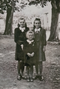 Marie Mikolášková with her younger sister and a friend, far left, 1944