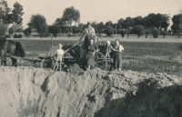 Crater left after a bomb hit a field near Semtín, uncle of the witness with his family, Pardubice, 1944