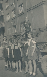 Blanka Lanštiaková (with white ribbon) with other children near a Soviet tank, Prague, 1945