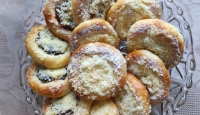 Cakes baked for the filming by the witness and her husband (she kneads the dough, her husband mixes it, then knocks it out, she makes the loaves and puts them on a baking tray to rise, her husband makes the pits and puts the filling, she spreads the butter)
