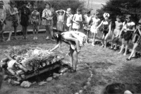 One of the camp girls at the fire with the offering