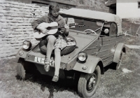 Daughter Irena with a guitar on the hood of a German military car, which the family used for holidays, 1968