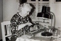 Božena Stehlíková at home while working on a part of the Dopleta knitting machine developed by her sons Jiří and Jaroslav