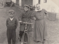 Jiri's great-grandmother (maternal grandfather's mother) Anna Hodanová in the yard of a farm in Malechov near Švihov, Jiri's uncle Jiří Hodan is on a bicycle next to her, 1959