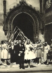 Newlyweds Zdeněk and Jarmila Weitosch walking through the ceremonial gate made of geodetic tracers, 1961