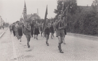 Festive march of the Junák in Slatiňany on the occasion of the opening of the Domeček scout clubhouse; Stanislav Řídký is first from left in front with the American flag, 1945