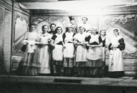 The amateur theatre from Skřipov during the rehearsal of the play The Pearls of the Virgin Serafinka. On the left Mrs. Satková in the role of Serafinka, on the right Jarmila Chovancová. The Count was played by Josef Balhar - in the photo with his hat. The man in black is the leader of the ensemble, teacher Král from Skřipov, between 1951-1952.