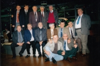 Witness seated first from left, his wife fourth from left, meeting of motor sport champions, 2001