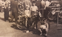 Rudolf Průcha on a motorcycle, one of his brothers (nine years older) standing next to him, his sister on the right, ca. 1953